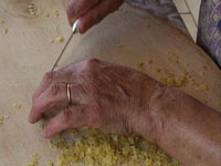 a woman making traditional Greek pasta